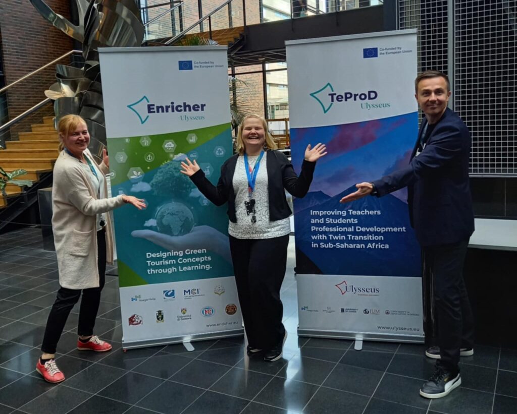 Speakers in front of the project roll-ups after the session.